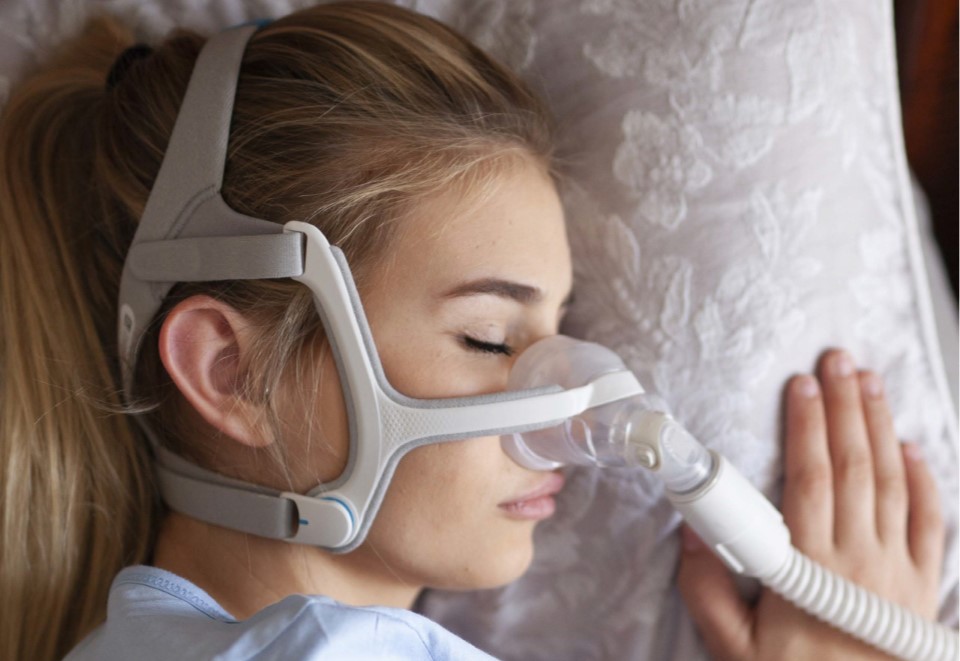 Woman sleeping in a CPAP mask
