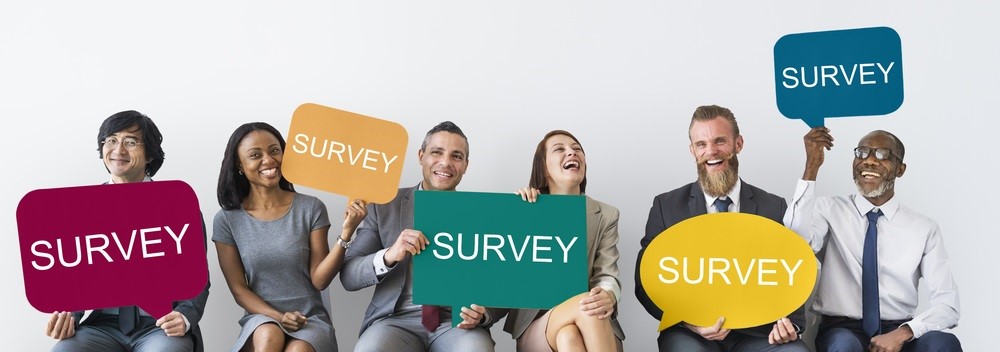People holding signs that read "survey"
