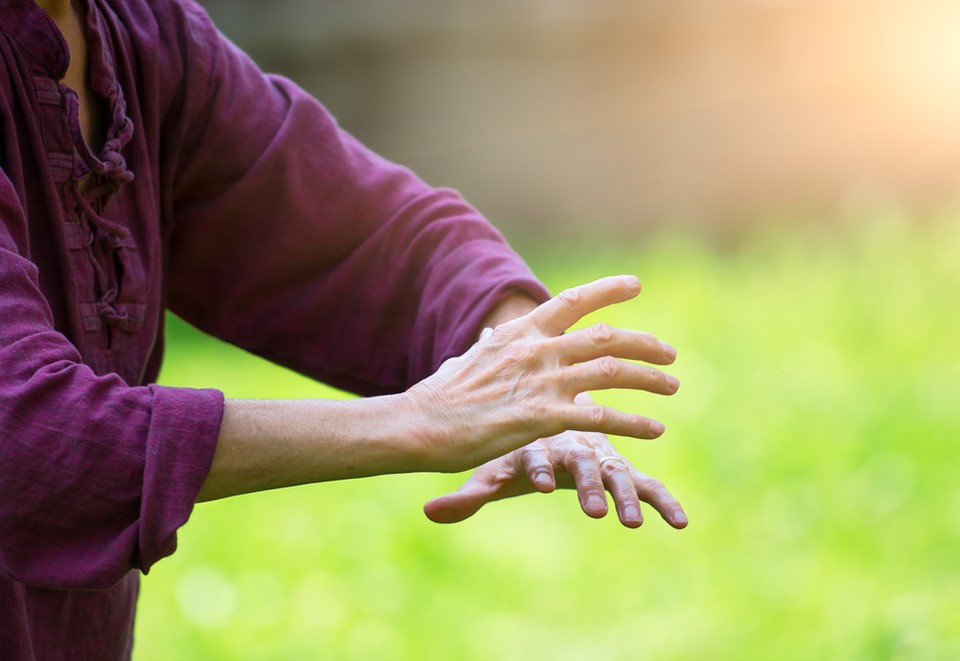 person holding hands in Tai Chi pose