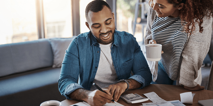 Man and woman working to figure out how to afford buying a home