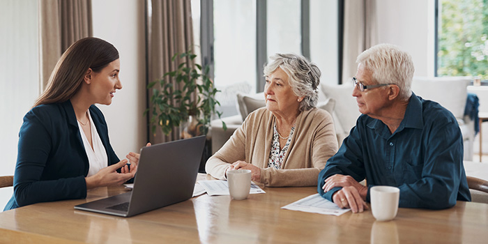 Older woman and man reviewing financial options with a counselor