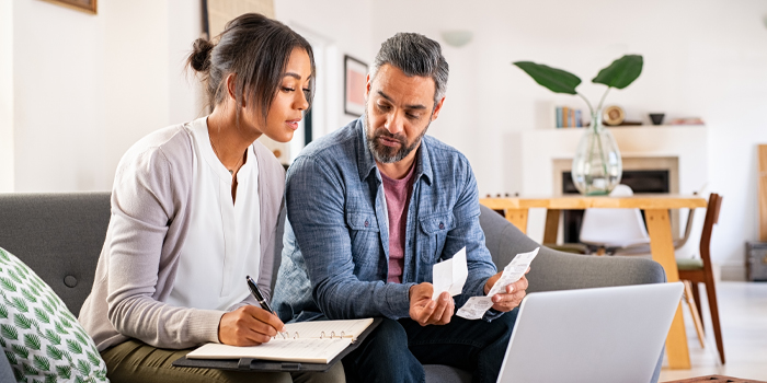 A man and woman reviewing receipts and expenses