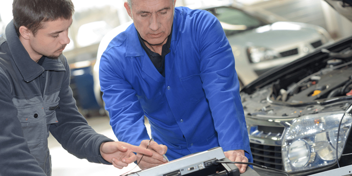 Two auto technicians at work