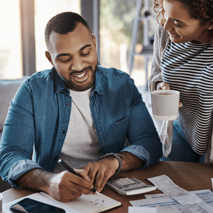 Man and woman working to figure out how to afford buying a home