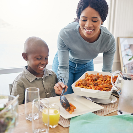 Mother serving her son a healthy dinner