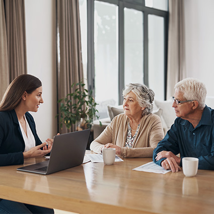 Older woman and man reviewing financial options with a counselor