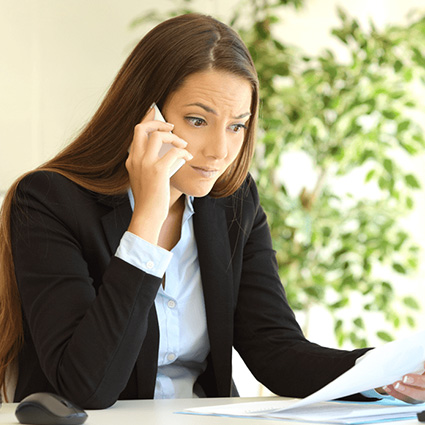 Concerned woman listening on a cell phone