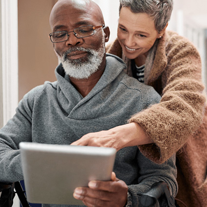 Volunteer helping veteran with a tablet