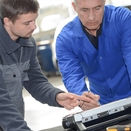 Two auto technicians at work