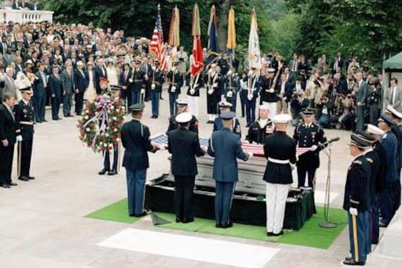 The presidential wreath is brought forward toward President Ronald Reagan during the interment ceremony for the unknown serviceman of the Vietnam era at the Tomb of the Unknown Soldier, Arlington National Cemetery, May 28, 1984.