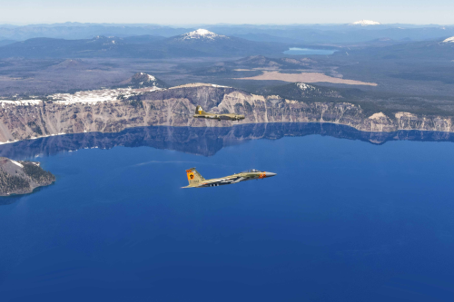 An Air Force F-15 Eagle flies in formation with a WWII-era B-17 during Sentry Eagle over Crater Lake, Ore., June 24, 2022. The exercise allows pilots to train against dissimilar aircraft and to practice aerial refueling and combat operations. Photo credit: Air Force Staff Sgt. Penny Snoozy.