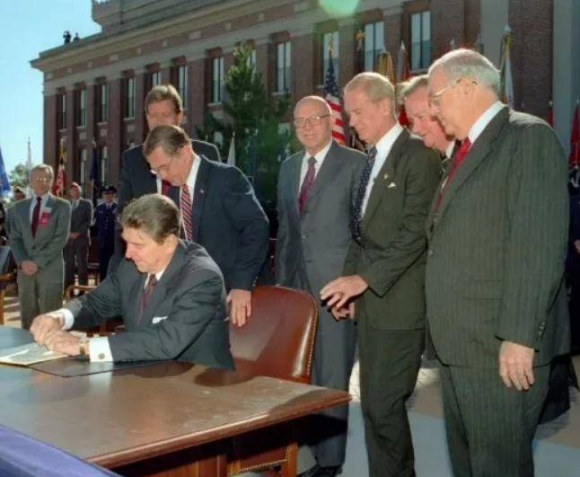 President Reagan signing of Department of Veterans Affairs Act HR 3471 at the National Defense University in Fort McNair, Virginia on October 25, 1988, elevating VA to a cabinet-level executive department.